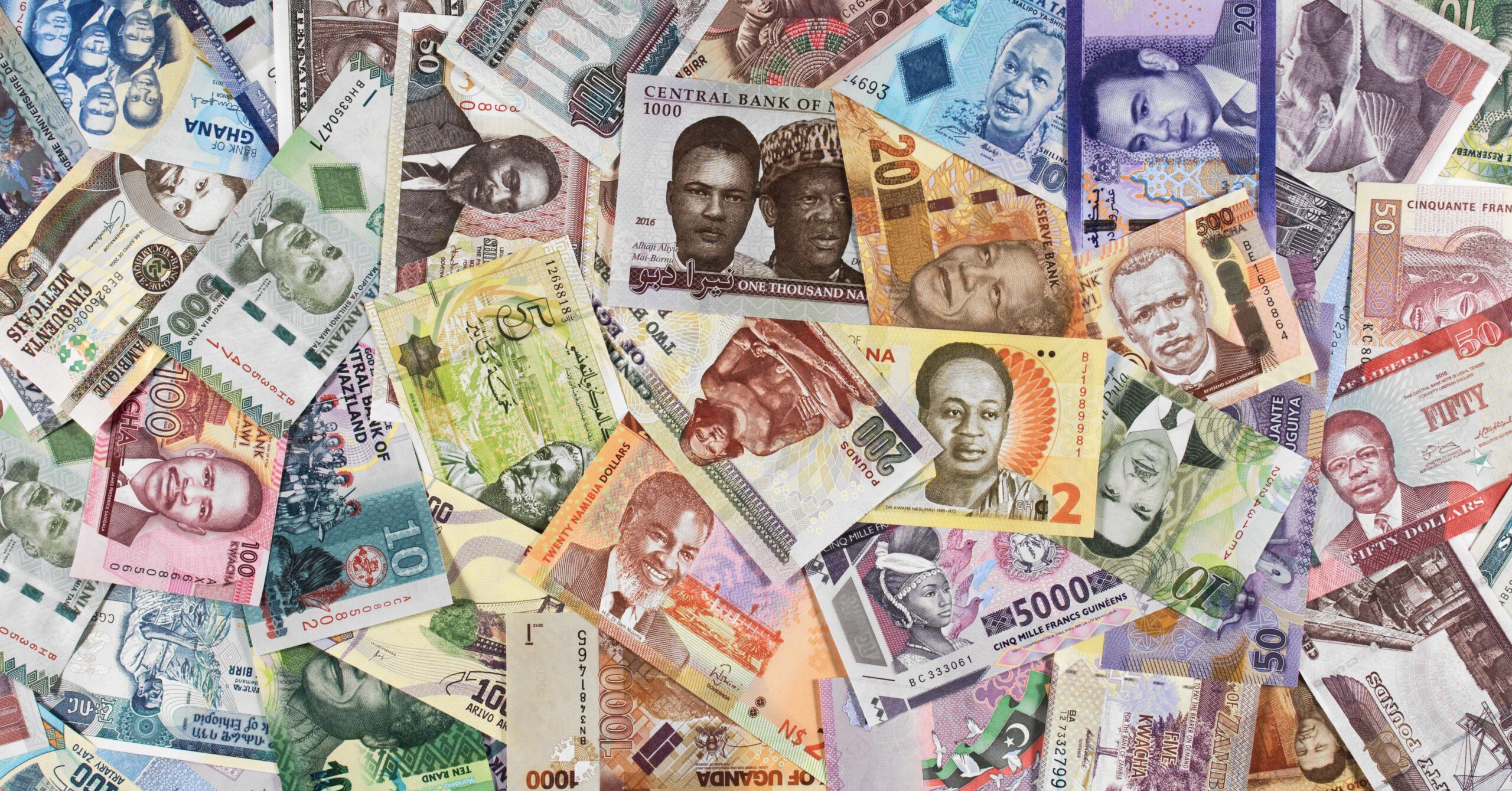 Close up image of African currency notes from Ghana, Mozambique, Nigeria, Guinea, Malawi, DRC, Uganda, Liberia, Egypt, Sudan, Namibia, Ethiopia, Swaziland